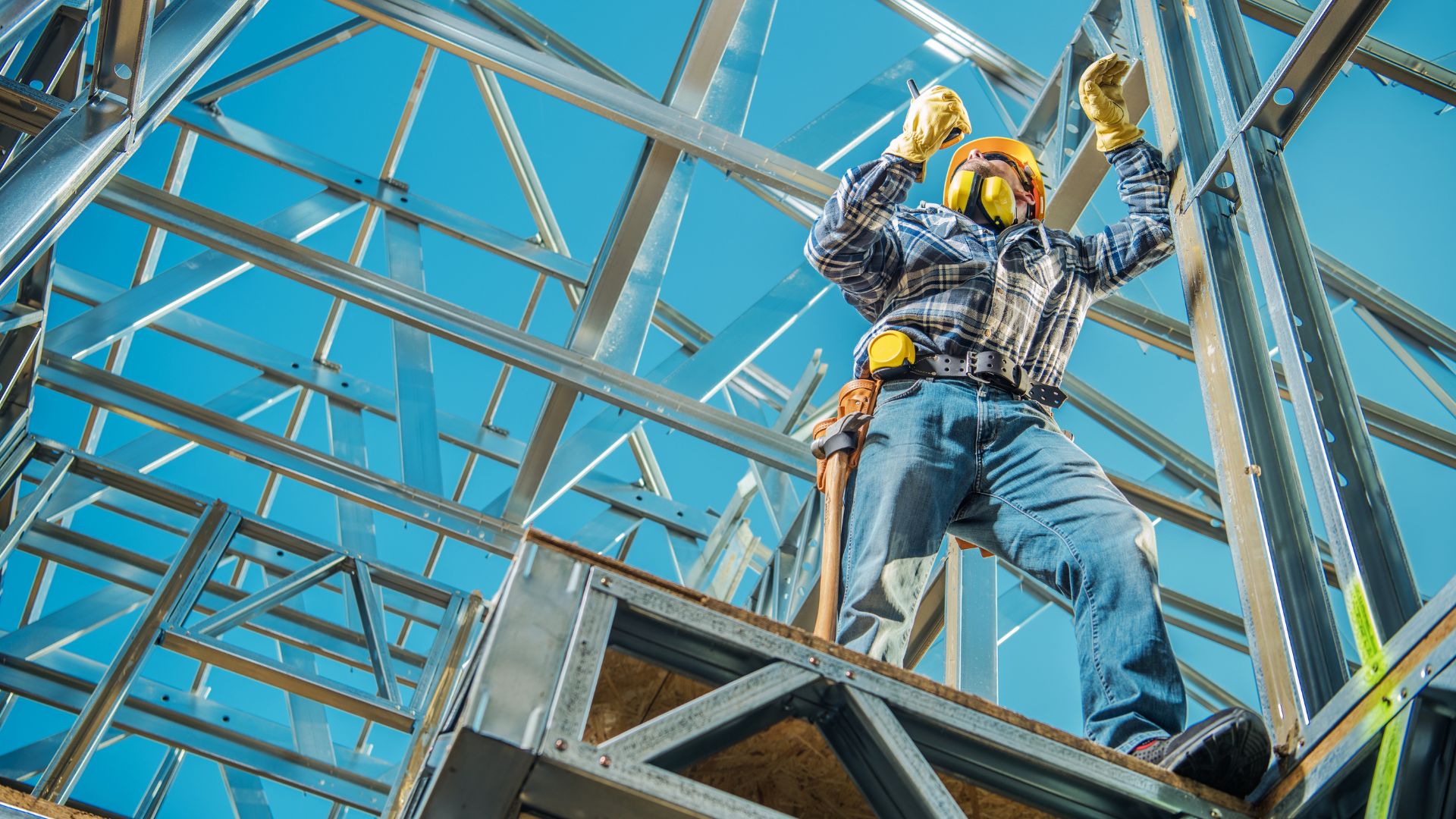 A construction worker working on a metal structure