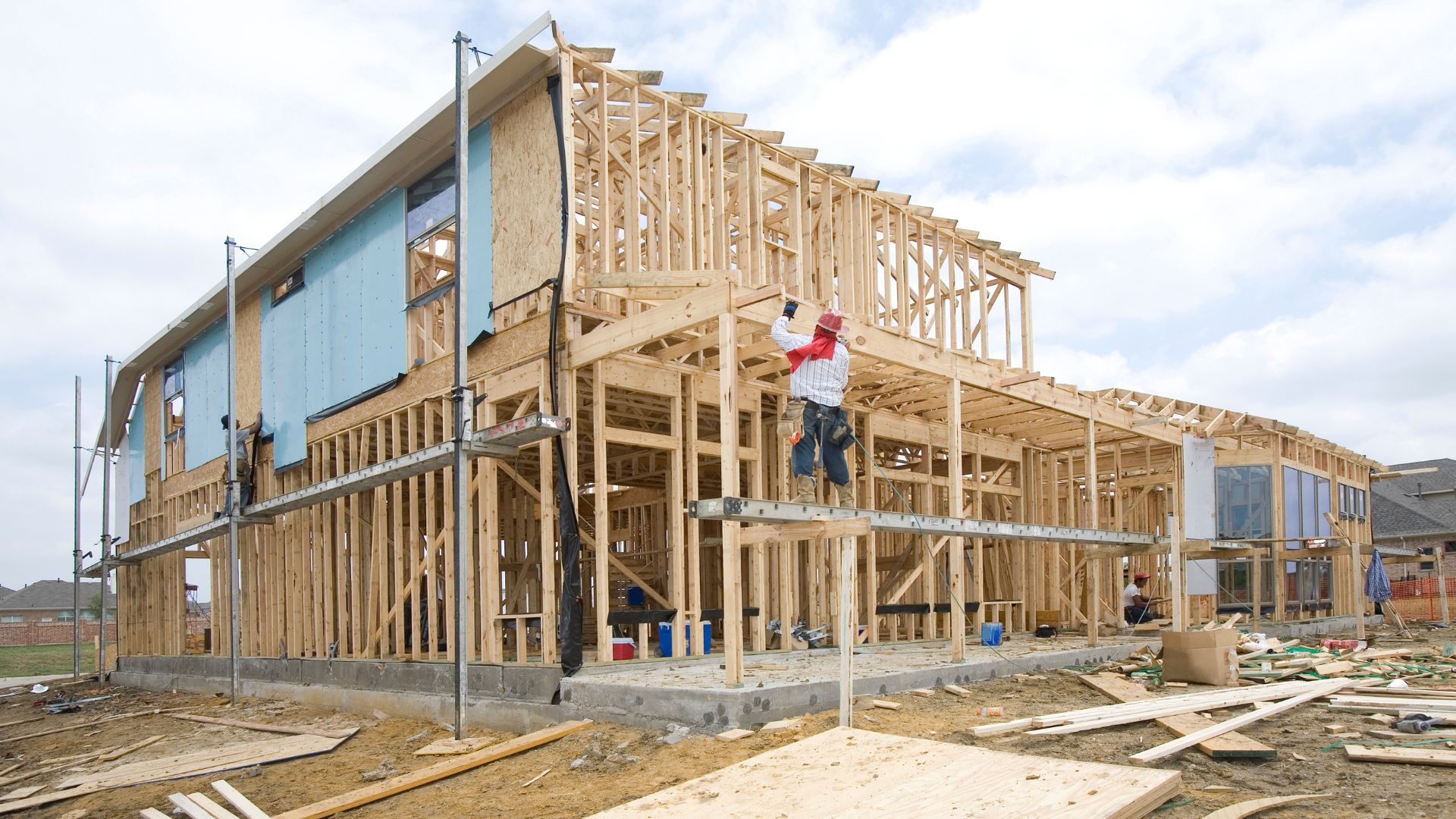 A man standing on top of a wooden structure